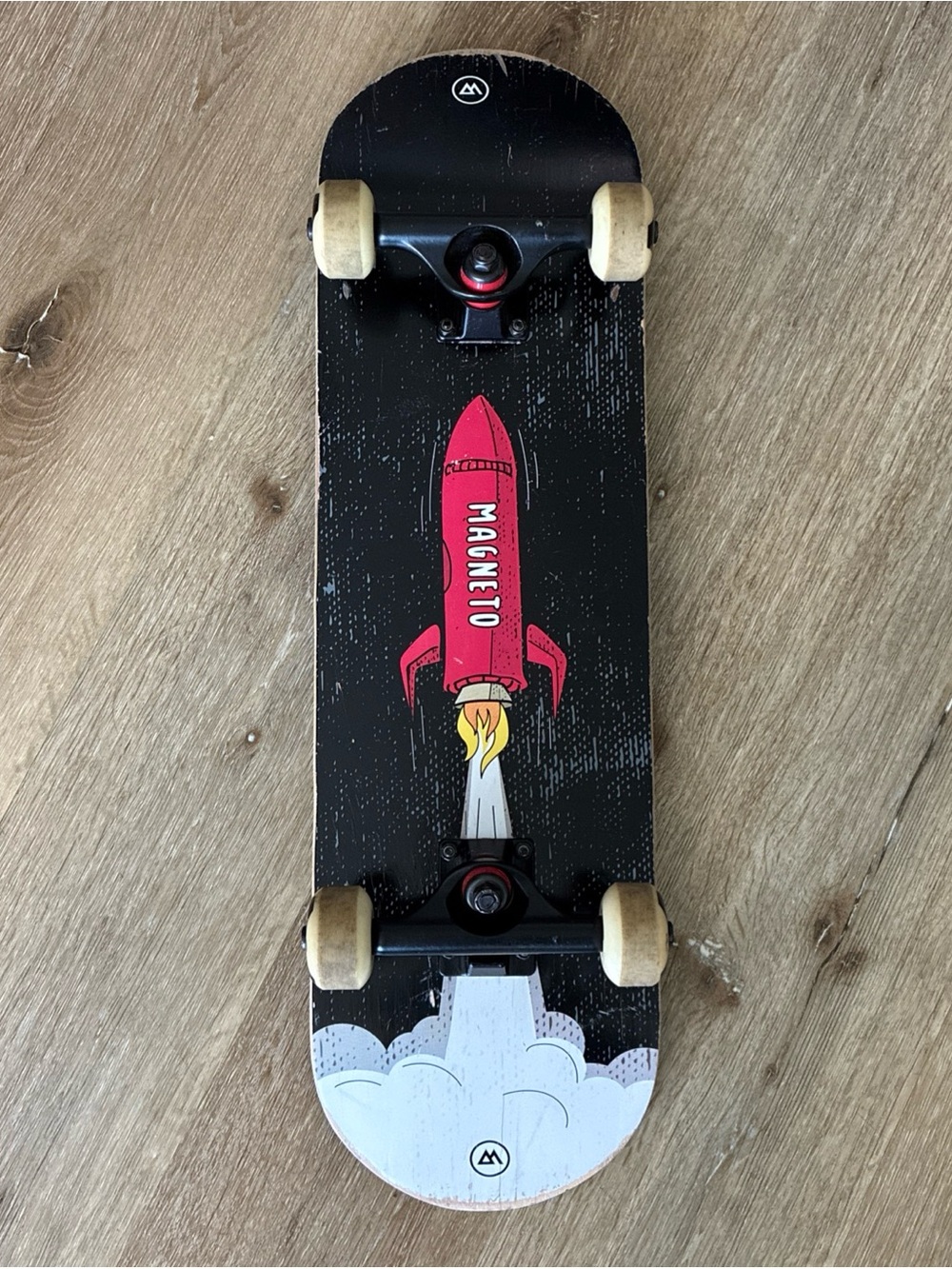 Magneto Rocket Kids 7.75" Skateboard Featuring A Prominent Red Rocket